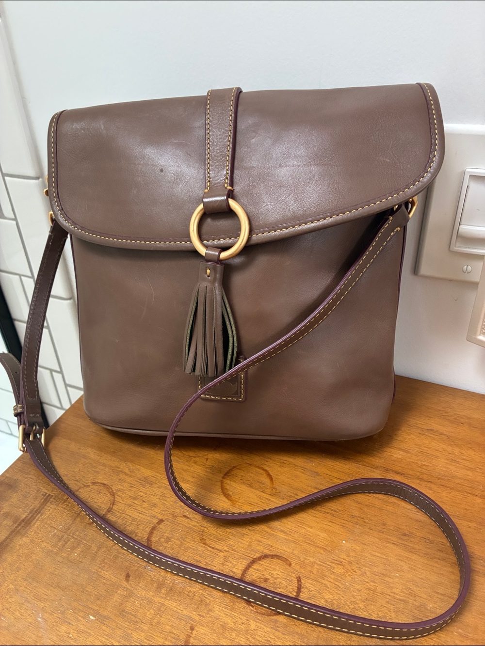 Dooney & Bourke Brown Leather Crossbody with Tassel and Gold Ring